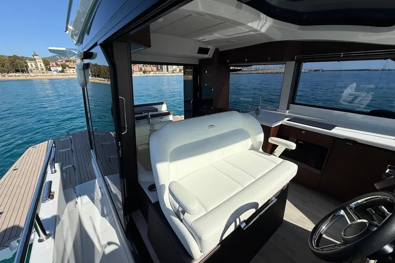  Yacht Photos Pics Interior of 2024 Galeon 410 HTC yacht with white seating and ocean view.
