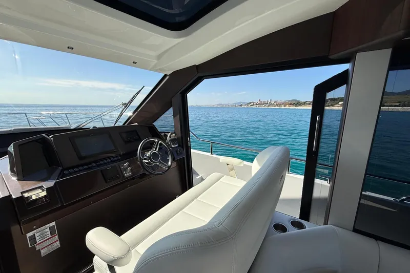  Yacht Photos Pics Interior view of 2024 Galeon 410 HTC yacht helm with ocean backdrop.