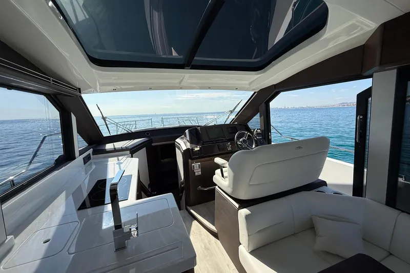  Yacht Photos Pics Interior view of 2024 Galeon 410 HTC yacht with modern helm and seating.