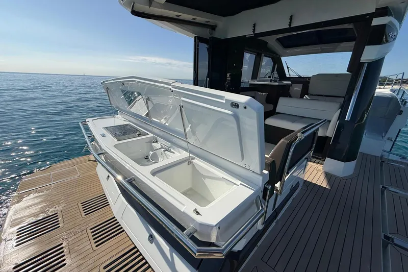  Yacht Photos Pics 2024 Galeon 410 HTC yacht with open deck storage, luxurious seating, and ocean view.