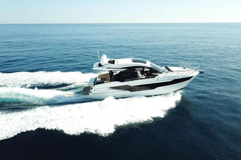  Yacht Photos Pics 2024 Galeon 410 HTC yacht cruising on open sea, creating a dynamic wake.