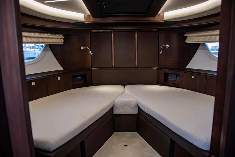  Yacht Photos Pics Luxurious cabin interior of 2025 Galeon 410 HTC yacht with twin beds and elegant wood finish.