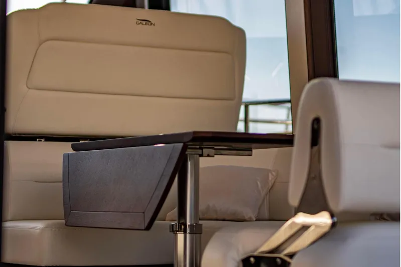  Yacht Photos Pics Luxurious interior of 2025 Galeon 410 HTC yacht with elegant seating and table.
