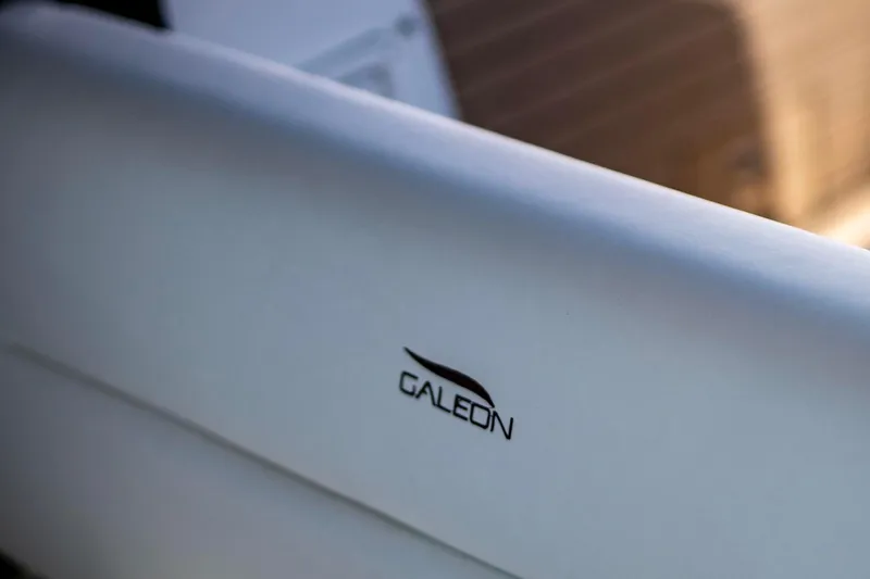  Yacht Photos Pics Close-up of 2025 Galeon 410 HTC logo on a sleek white surface.