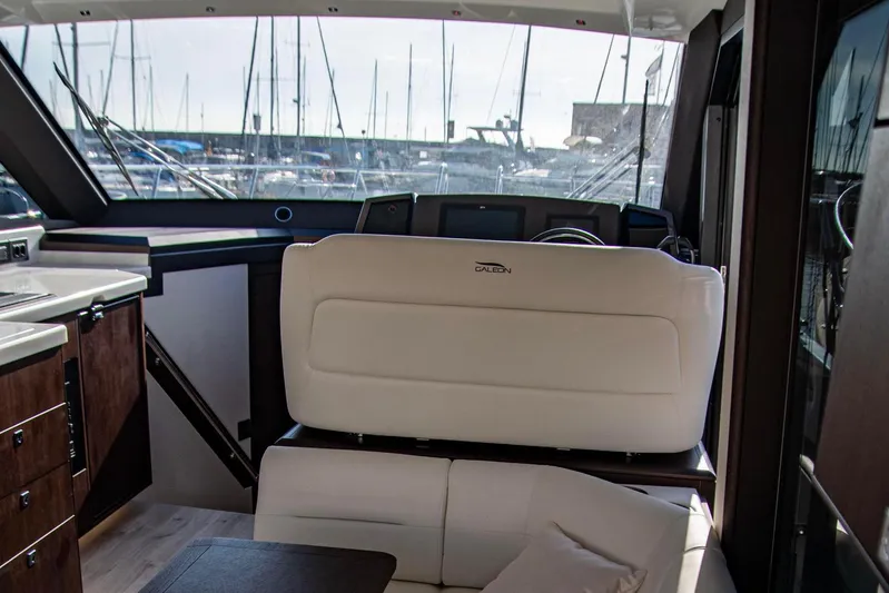  Yacht Photos Pics Interior of 2025 Galeon 410 HTC yacht with modern seating and helm.