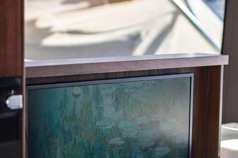  Yacht Photos Pics Interior of 2025 Galeon 410 HTC yacht with a built-in TV and wooden paneling.