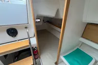 Interior of 2011 Maree Haute DJANGO 770 sailboat, featuring compact cabin space and wooden accents.