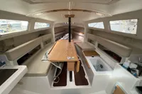 Interior of 2011 Maree Haute DJANGO 770 sailboat, featuring seating and a central table.