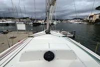 Sailboat Maree Haute DJANGO 770 docked in a marina, overcast sky, 2011 model.