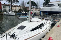 Sailboat Maree Haute DJANGO 770, 2011 model, docked in a marina with other boats.