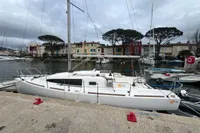 Sailboat Maree Haute DJANGO 770, 2011 model, docked in a marina with colorful houses.