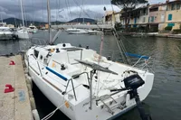 Sailboat Maree Haute DJANGO 770, 2011 model, docked in a marina with scenic background.