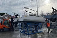 Sailboat Maree Haute DJANGO 770, 2011, on a stand in a shipyard with forklift nearby.