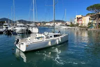 Sailboat Maree Haute DJANGO 770, 2011 model, docked in a scenic marina.