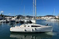 Sailboat Maree Haute DJANGO 770, 2011 model, docked in a marina under clear blue skies.