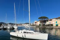 Sailboat Maree Haute DJANGO 770, 2011 model, docked in a scenic marina.