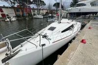 Sailboat Maree Haute DJANGO 770, 2011 model, docked in a marina with surrounding boats.