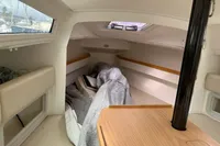 Interior of 2011 Maree Haute DJANGO 770 sailboat cabin with wooden table and window.