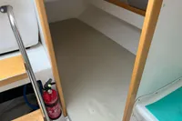 Interior cabin of 2011 Maree Haute DJANGO 770 sailboat with fire extinguisher.