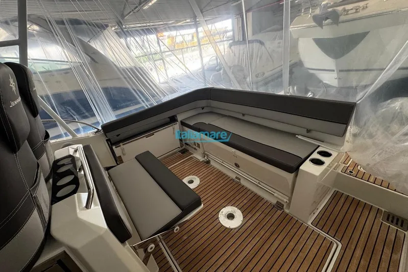 Gigage Yacht Photos Pics 2020 Jeanneau Cap Camarat 9.0 WA interior with seating and wood flooring.