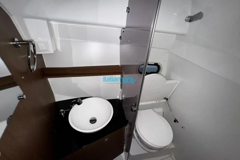 Gigage Yacht Photos Pics 2020 Jeanneau Cap Camarat 9.0 WA boat bathroom with sink and toilet.