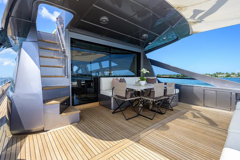 Shine Yacht Photos Pics Luxurious 2022 Pershing 9X yacht deck with elegant seating and ocean view.