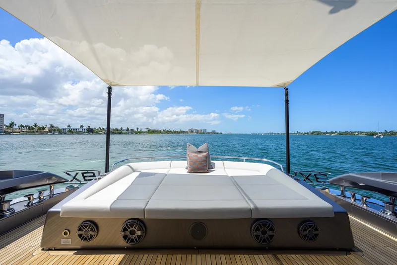 Shine Yacht Photos Pics Luxury Pershing 9X yacht deck with sunbed, ocean view, and canopy, 2022 model.
