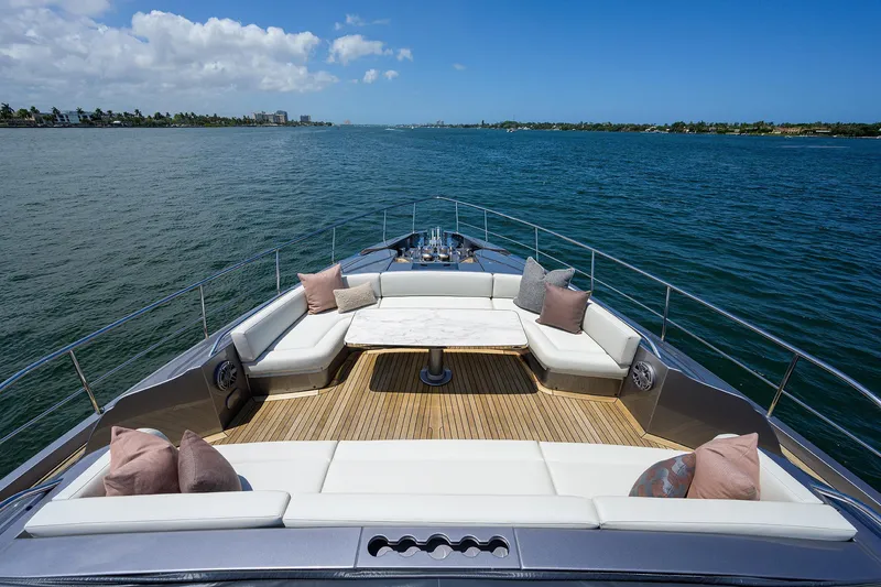 Shine Yacht Photos Pics Luxurious 2022 Pershing 9X yacht deck with elegant seating and ocean view.