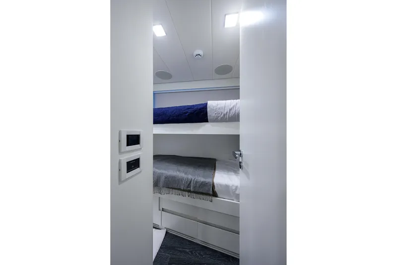 Shine Yacht Photos Pics Interior of 2022 Pershing 9X yacht featuring modern bunk beds and sleek design.