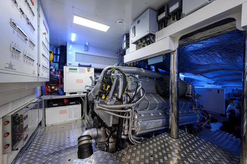 Shine Yacht Photos Pics Engine room of 2022 Pershing 9X yacht with advanced machinery and control panels.
