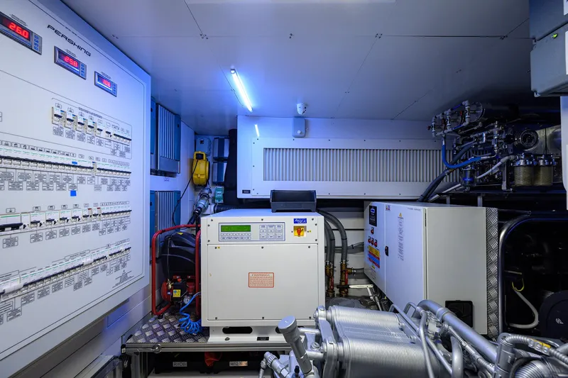 Shine Yacht Photos Pics Engine room of 2022 Pershing 9X yacht with control panels and machinery.