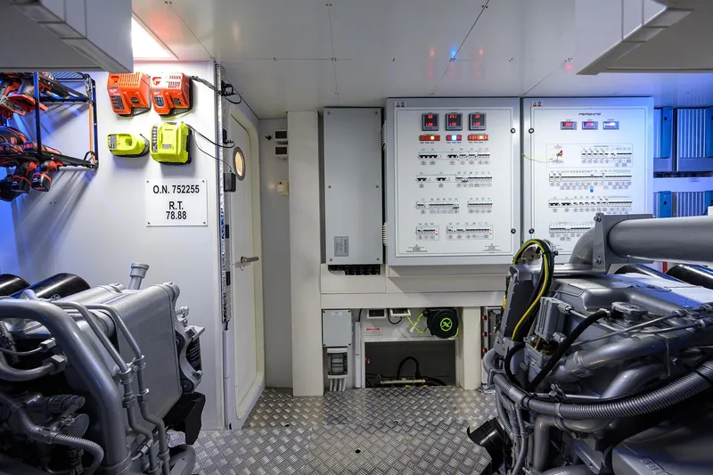 Shine Yacht Photos Pics Engine room of 2022 Pershing 9X yacht with control panels and machinery.