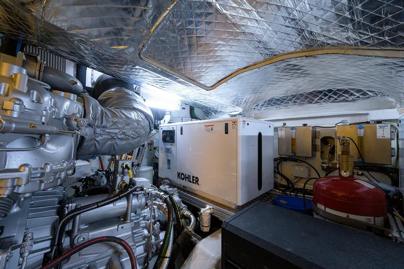 Shine Yacht Photos Pics Engine room of 2022 Pershing 9X yacht featuring Kohler generator and advanced machinery.