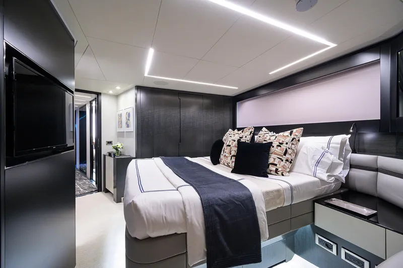 Shine Yacht Photos Pics Luxurious bedroom interior of 2022 Pershing 9X yacht with modern design and elegant decor.