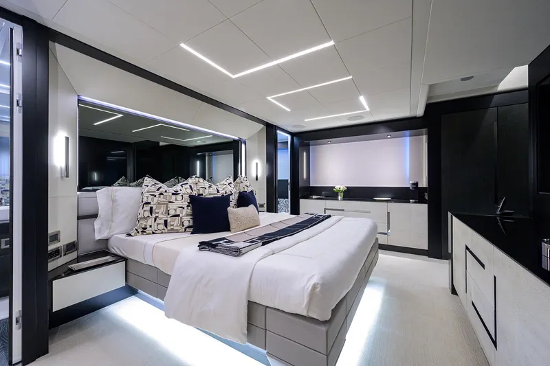 Shine Yacht Photos Pics Luxurious bedroom interior of 2022 Pershing 9X yacht with modern design and elegant lighting.