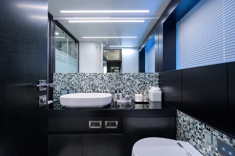 Shine Yacht Photos Pics Luxurious bathroom interior of 2022 Pershing 9X yacht with modern fixtures and mosaic tiles.