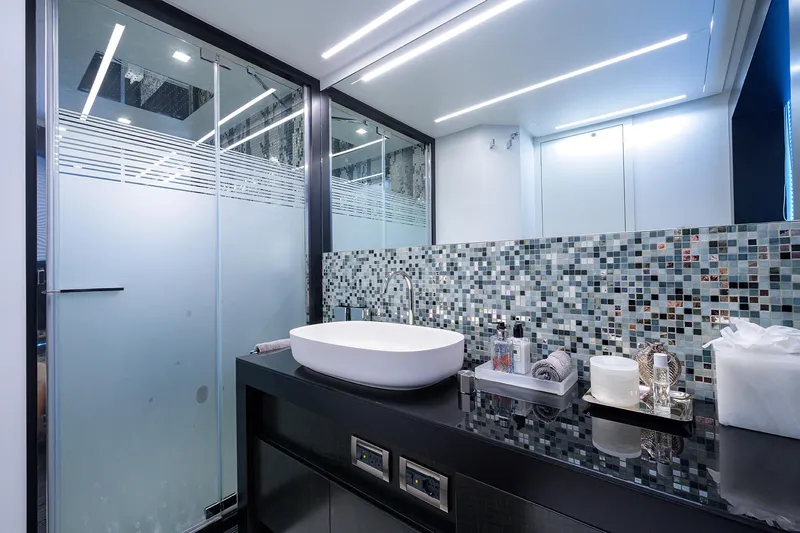 Shine Yacht Photos Pics Luxurious bathroom in 2022 Pershing 9X yacht with modern sink and mosaic tiles.