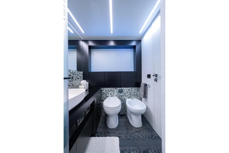 Shine Yacht Photos Pics Modern bathroom interior on 2022 Pershing 9X yacht, featuring sleek design and mosaic tiles.
