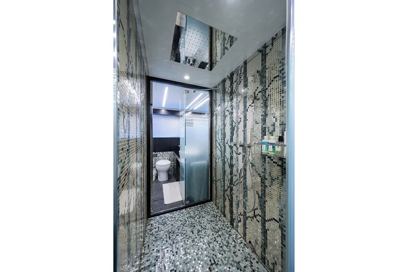 Shine Yacht Photos Pics Luxurious Pershing 9X 2022 yacht bathroom with mosaic tiles and modern fixtures.