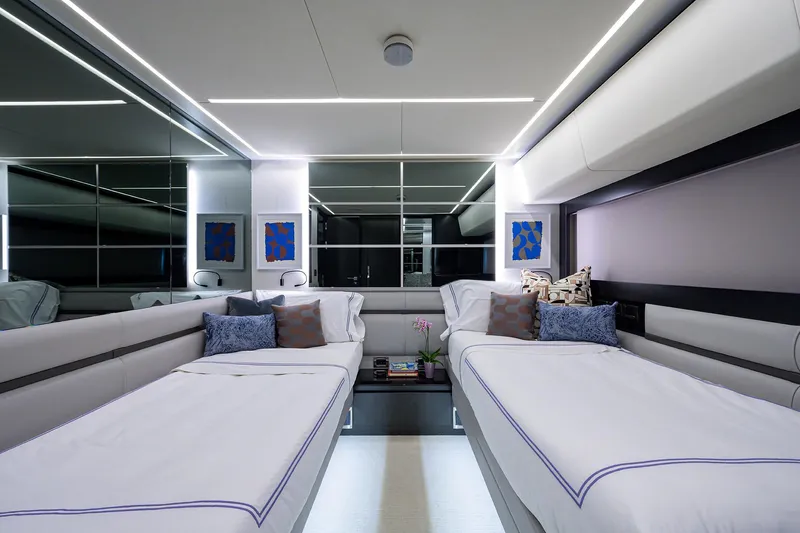 Shine Yacht Photos Pics Luxurious 2022 Pershing 9X yacht interior with modern twin beds and elegant decor.