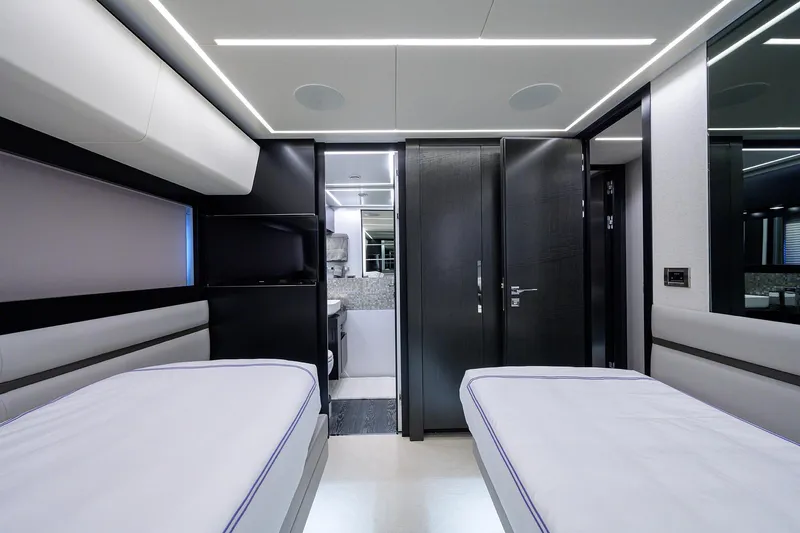 Shine Yacht Photos Pics Luxurious interior of 2022 Pershing 9X yacht with modern twin beds and sleek design.