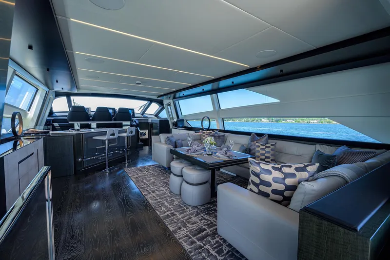 Shine Yacht Photos Pics Luxurious interior of 2022 Pershing 9X yacht with elegant seating and panoramic windows.