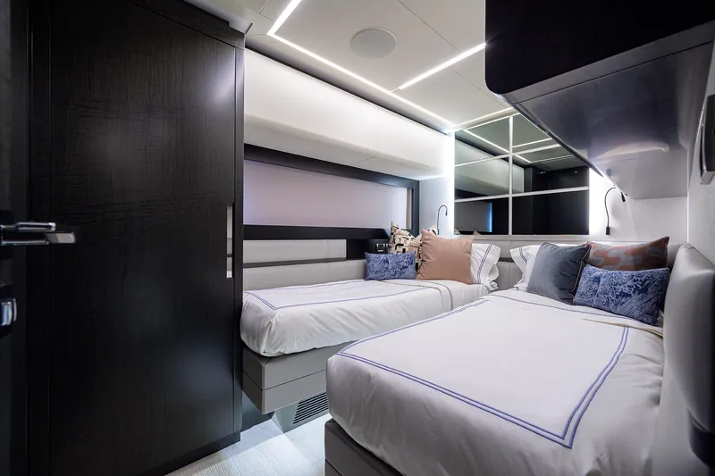 Shine Yacht Photos Pics Luxurious twin bedroom interior on 2022 Pershing 9X yacht, featuring modern design and elegant decor.