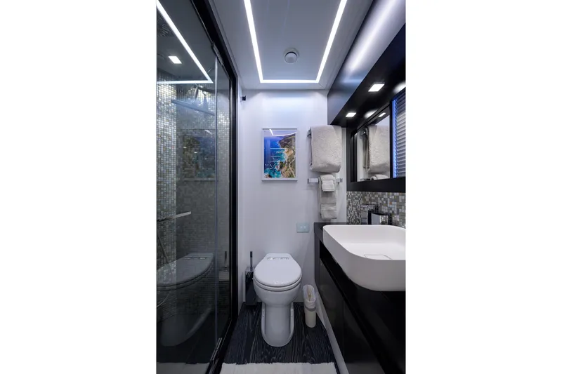Shine Yacht Photos Pics Luxurious bathroom in 2022 Pershing 9X yacht with modern fixtures and elegant design.