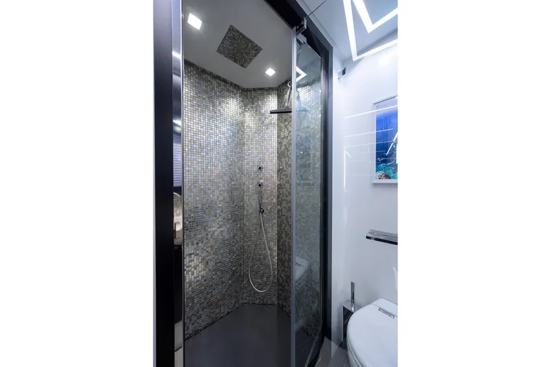 Shine Yacht Photos Pics Luxurious shower in 2022 Pershing 9X yacht with mosaic tiles and modern fixtures.
