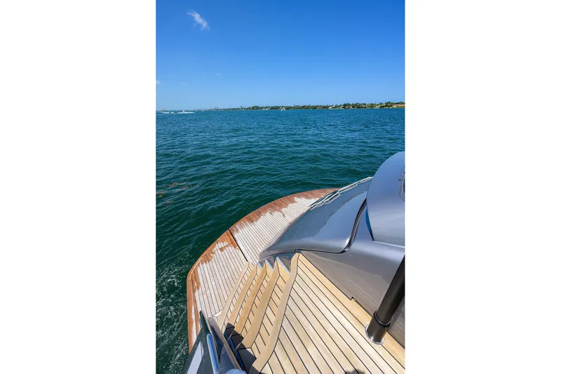 Shine Yacht Photos Pics Luxury Pershing 9X yacht deck overlooking serene blue ocean, 2022 model.