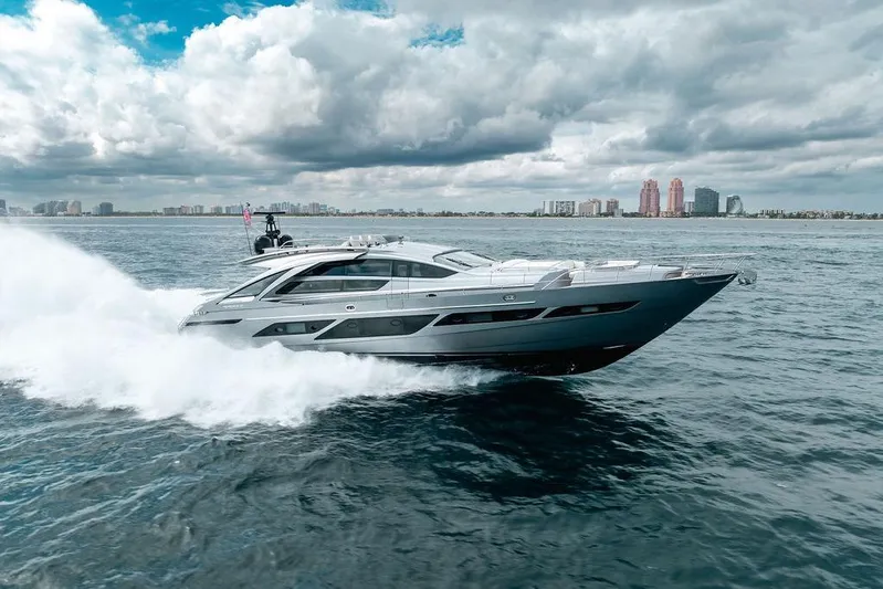 Shine Yacht Photos Pics 2022 Pershing 9X yacht cruising on open water under cloudy skies.