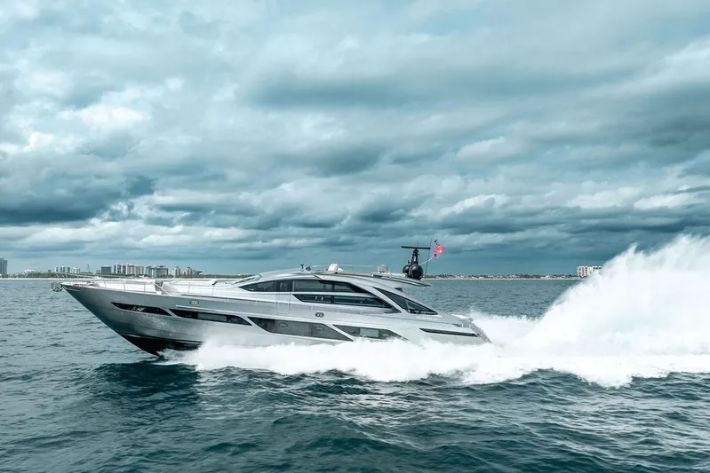 Shine Yacht Photos Pics 2022 Pershing 9X yacht cruising on open water under cloudy skies.