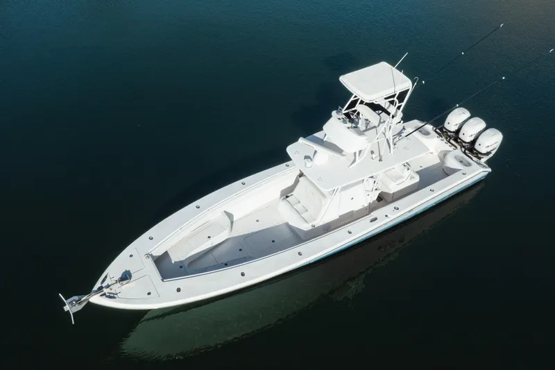  Yacht Photos Pics Aerial view of 2009 SeaHunter 40 boat with triple outboard engines on calm water.