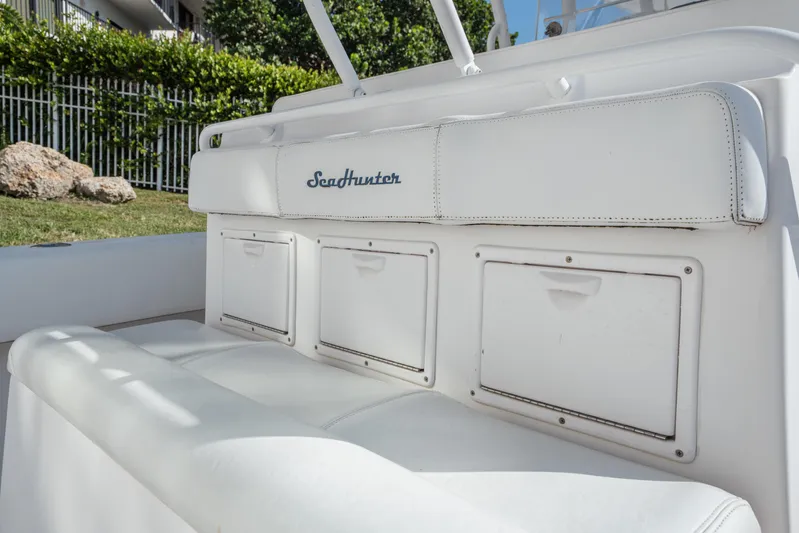  Yacht Photos Pics 2009 SeaHunter 40 boat seating with storage compartments, white upholstery, outdoor setting.